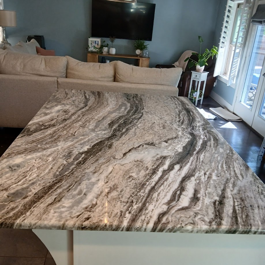 Brown Fantasy marble close-up showing dramatic brown and cream flowing veins — Heart of Texas Granite & Marble
